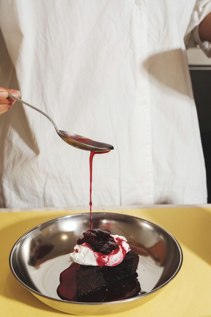 Cherry sauce poured over chocolate cake
