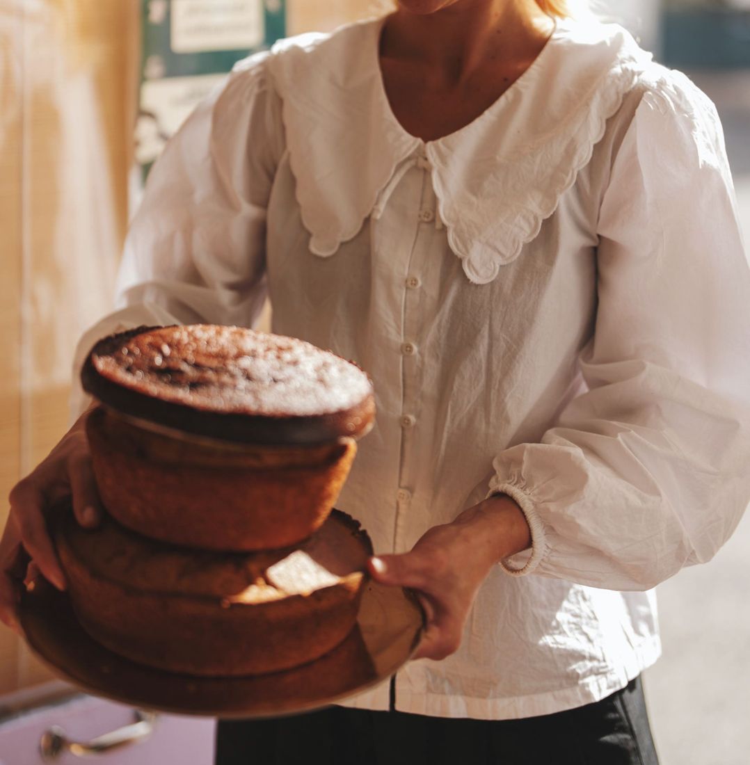 Fernanda holding a stack of cakes